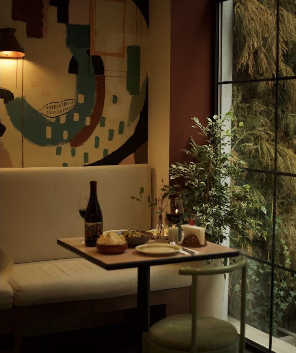 A cozy corner booth by the window at Maluli